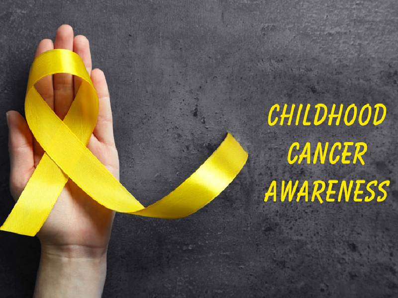 Image That Shows Child hands holding yellow gold ribbon, Childhood cancer Awareness.